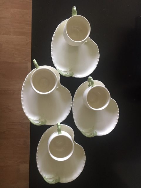 Vintage porcelain tea cups and biscuit plates